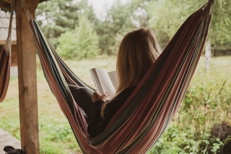 Combat the Sunday scaries, woman relaxing on a hammock reading