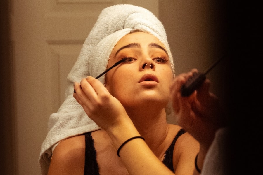 woman applying mascara for beauty boost