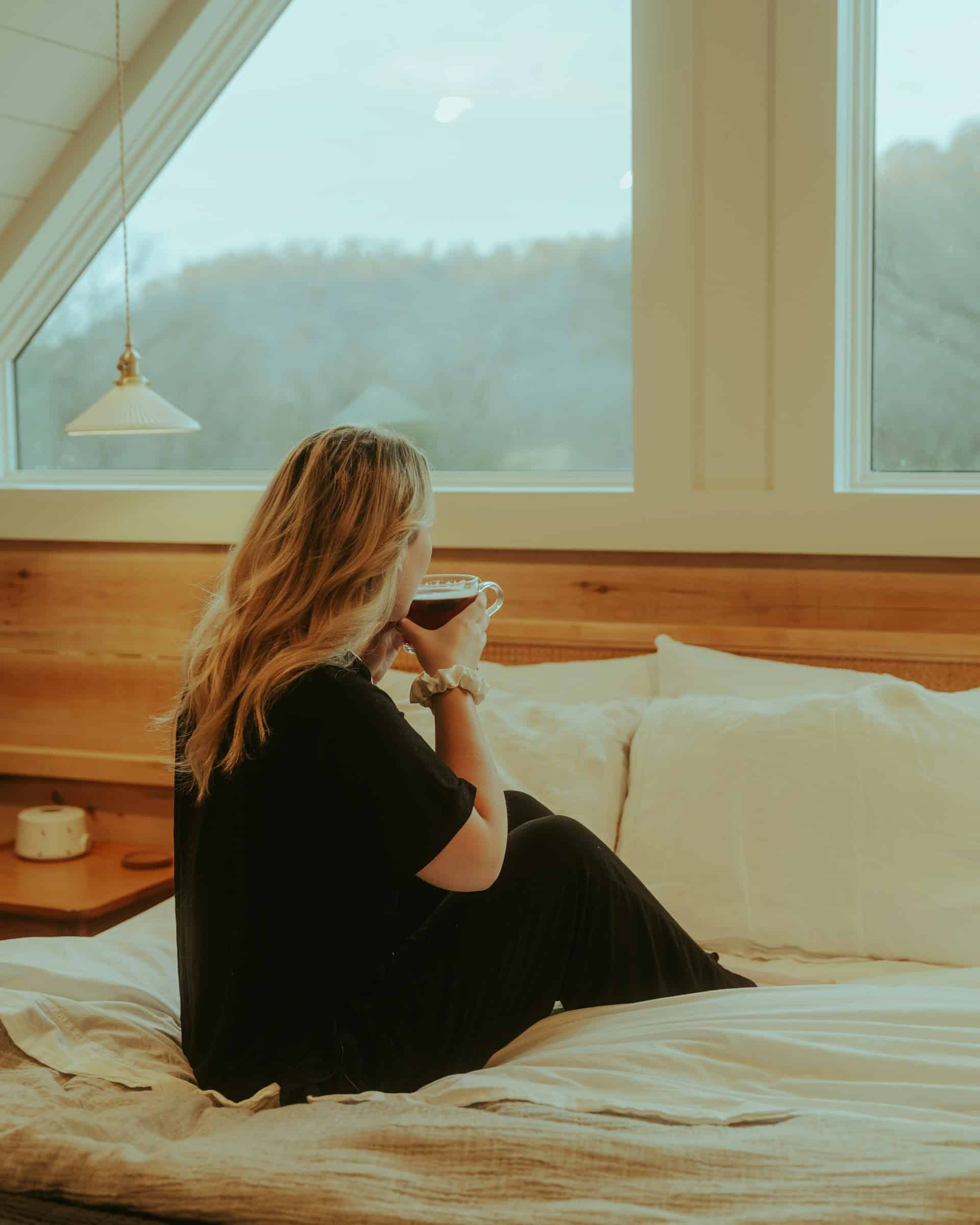 Woman waking up with coffee and sunlight practicing ADHD morning routine hacks