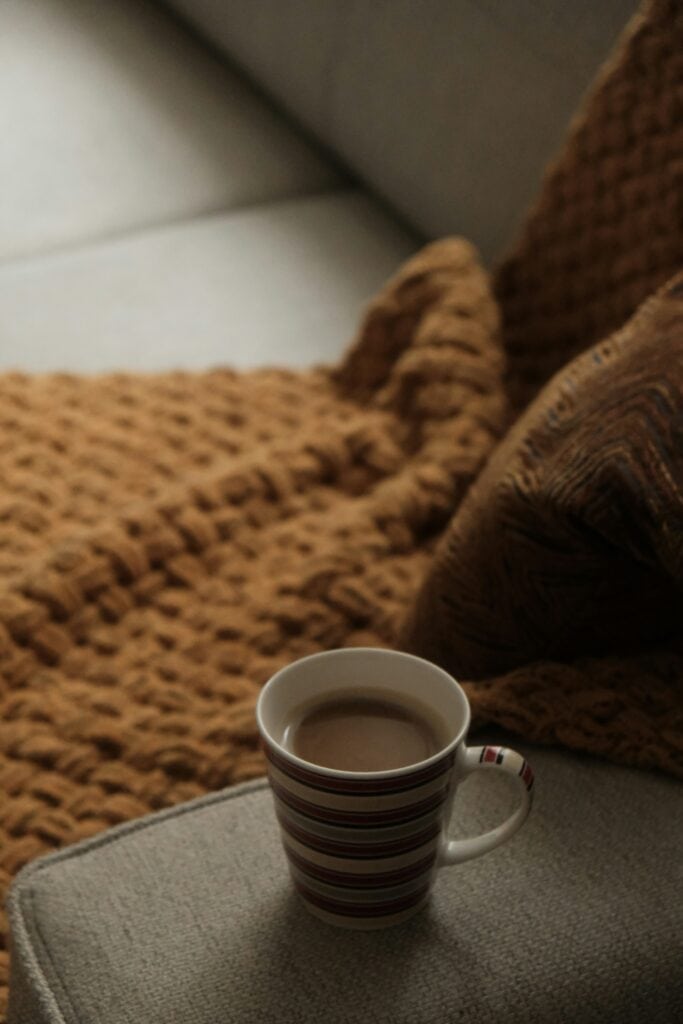 Cozy Sunday reset with a blanket and tea, part of ADHD Sunday habits routine.