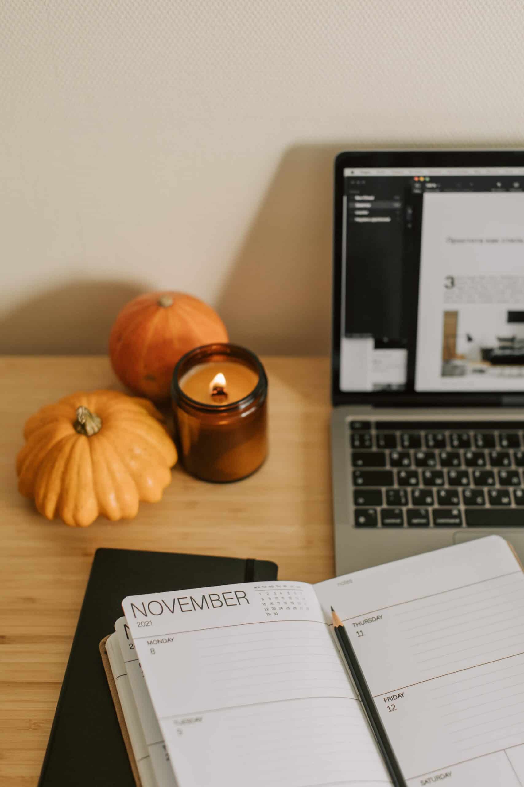 Cozy fall desk setup with planner, candle, and pumpkins for an ADHD fall reset routine.