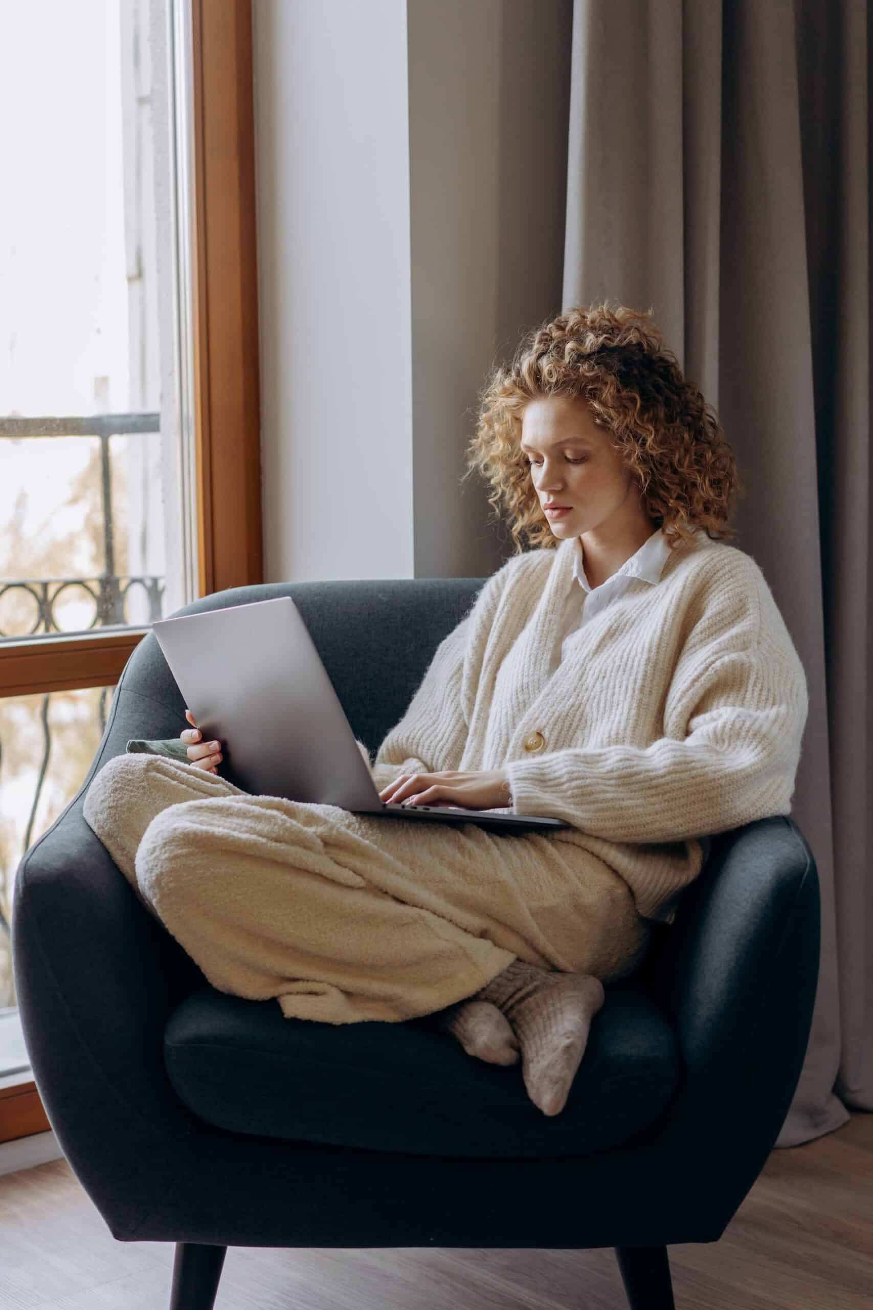 Tired woman working on laptop — ADHD fatigue and brain recharge concept.